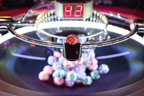 Colourful lottery balls in a rotating bingo machine. Number 23