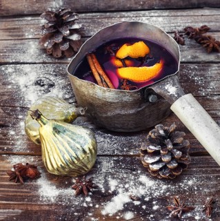 Old pot with long handle welded with mulled wine on the Christmas decor