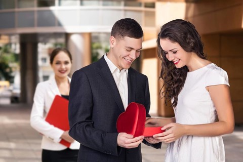 Happy young business women with a folder at the office building
