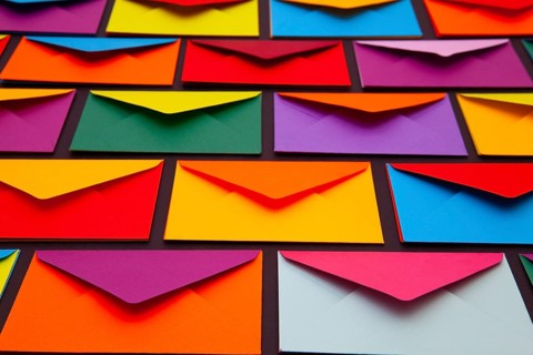 Composition with white and colored envelopes on the table. The photo suitable for various holidays