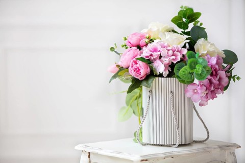 Beautiful peonies in a paper box on a white background