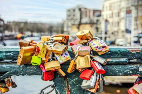Padlocks tied on a bridge as a symbol of eternal love in an Amsterdam channel