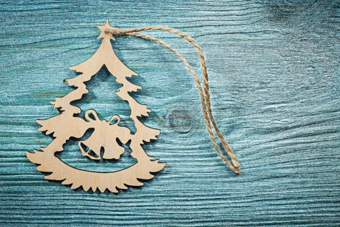 Vintage wooden Christmas toy string on wood board top view celebrations concept
