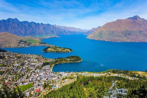 Huge azure lake among the mountains. Bird's eye view. Travel to New Zealand, South Island. The city