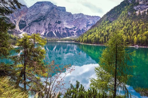 Stroll around the beautiful alpine lake Lago di Braies. The concept of walking and eco-tourism.