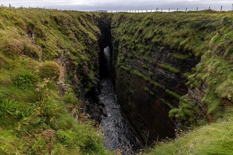 The Gloup, collapsed cave with small waterfall, Mull Head Local Nature Reserve, seaside nature