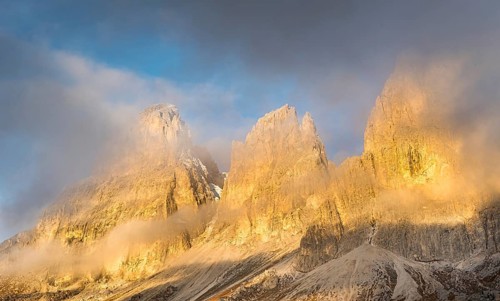 Foggy mountain landscape during sunrise of the picturesque Dolomiti at Passo Sella area in South