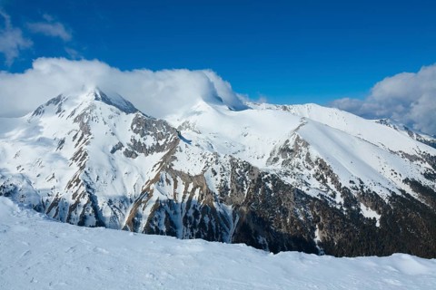 Tops of Pirin mountains view from top of cable car, ski resort Bansko, Bulgaria.