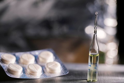 Pills, Syringe And Ampoule With Vaccination On Dark Table