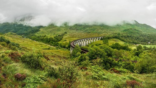 Glenfinnan railway viaduct (location from Harry Potter movie), on overcast day with grey sky and