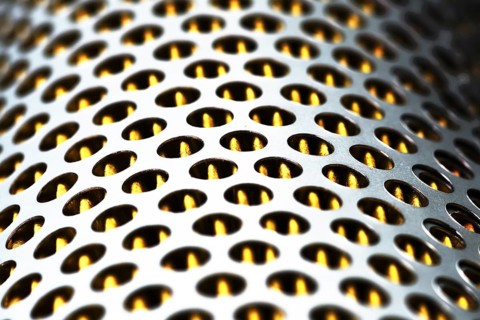 Detail of a tractor oil filter creates an industrial textured background
