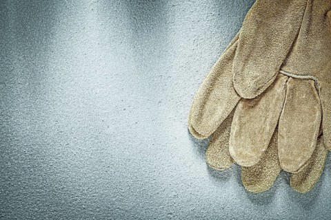 Safety gloves on concrete background construction concept