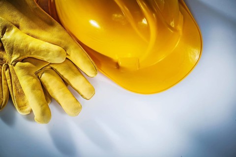 Leather protective gloves building helmet on white background