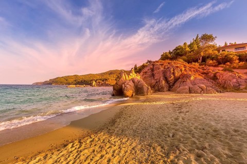 Vourvourou, Chalkidiki or Halkidiki, Greece summer sunset scenery with turquoise sea, forest green