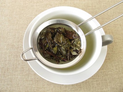 Peppermint tea in a tea strainer