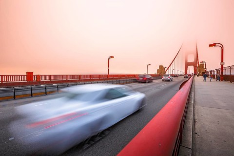 Cars crossing the San Francisco, Californian Golden Gate Bridge from the Presidio Pacific point to