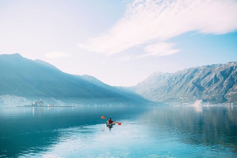 Kayaks in the lake. Tourists kayaking on the Bay of Kotor, near the town of Perast in Montenegro.