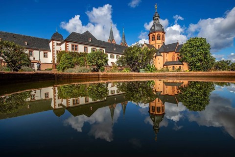 A historic monastery in the morning. Monastery walls, church and buildings are reflected in the