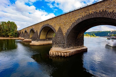 Pleasure boat. Romantic trip to medieval Germany. Scenic Baudouin bridge over the majestic river