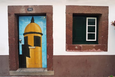 House wall with colourfully painted door, Madeira