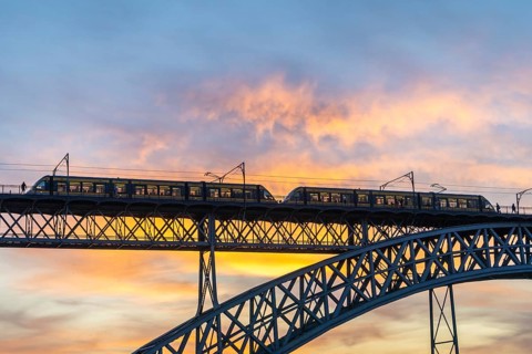 Porto City and Dom Luis Bridge I with Tram at Sunset. Colorful Sky. Portugal
