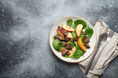 Healthy Salad with Iron Rich Ingredients Chicken Liver, Apples, Fresh Spinach and Walnuts on White