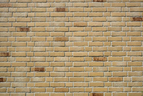 Background made from a wall of beige clinker bricks