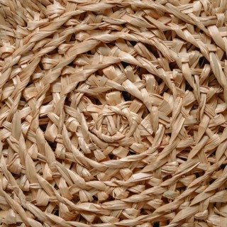 Circular pattern of woven seagrass basket. Abstract background - natural rattan or sea grass in