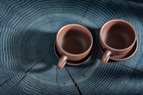 Two Empty Clay Coffee Cups On Wooden Background