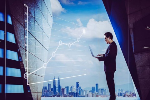 Businessman using laptop with graph statistical analysis, Business success concept