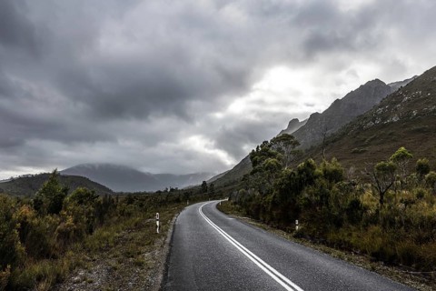The picturesque Gordon River Rd at the Sentinel range of mountains near Bitumen Bones Sculpture on