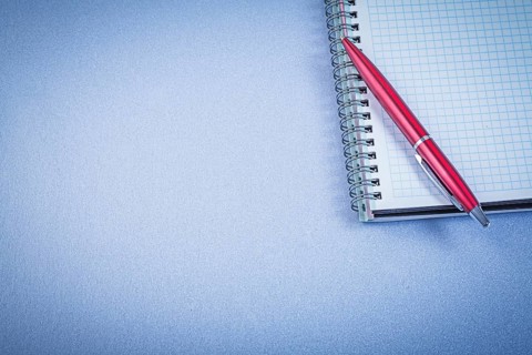 Red ball-point pen notepad office concept