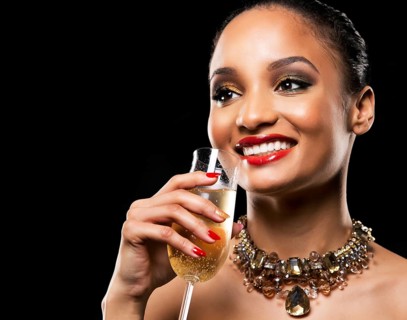 Romantic Indian woman with golden makeup and nailpolish. Big gold fashion necklace. Black isolated
