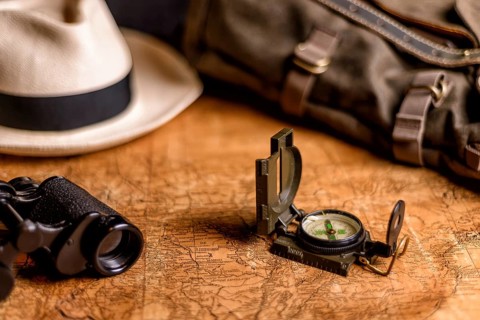 Old expedition map with compass and binoculars