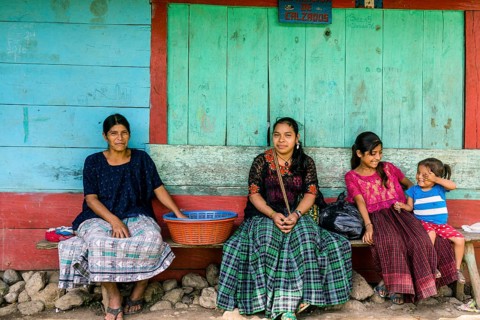 Women in front of a colorful wall, Lancetillo, La Parroquia, Reyna area, Quiche, Guatemala, Central