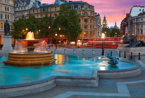 London Trafalgar Square fountain at sunset England