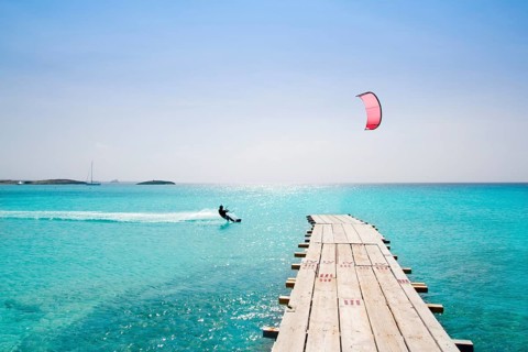 Formentera beach wood pier over turquoise water from balearic Mediterranean sea paradise