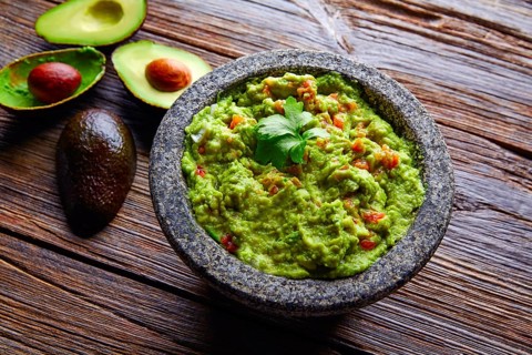 Avocado Guacamole on molcajete real Mexican traditional procedure