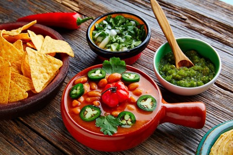 Frijoles charros mexican beans with chili pepper sides and tortillas