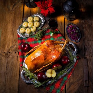 Festive stuffed roast goose with red cabbage and dumplings