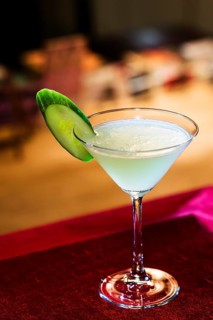 Modern blue martini cocktail with lime in bar