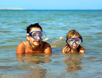 Happy summer vacation, snorkeling daughter with mother