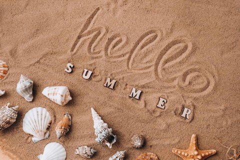Composition with text HELLO SUMMER seashells, pebbles, mockup on sand background. Blank, top view,