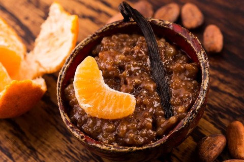 A bowl of chocolate tapioca pudding with fruits