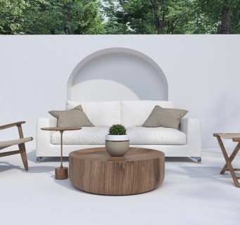Patio setup with a white couch, wooden elements, and surrounding greenery