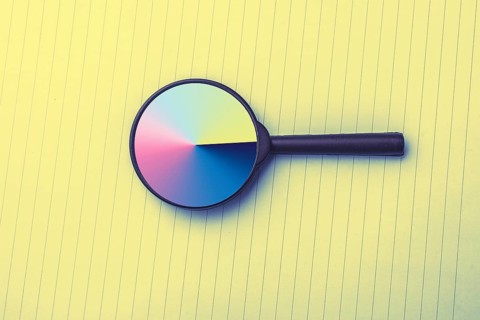 Looking through a magnifying glass to documents. Concept of search