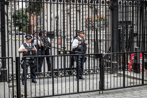 London, UK, August 18, 2015: Police officers protecting the gate of Downing street in London, the