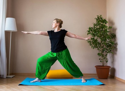 Middle aged or mature woman doing yoga indoors