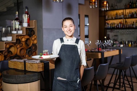 Ganson, officers, beautiful deushka with a smile and gathered hair in working form apron accepts an