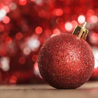 A red christmas bauble on the background of red boken